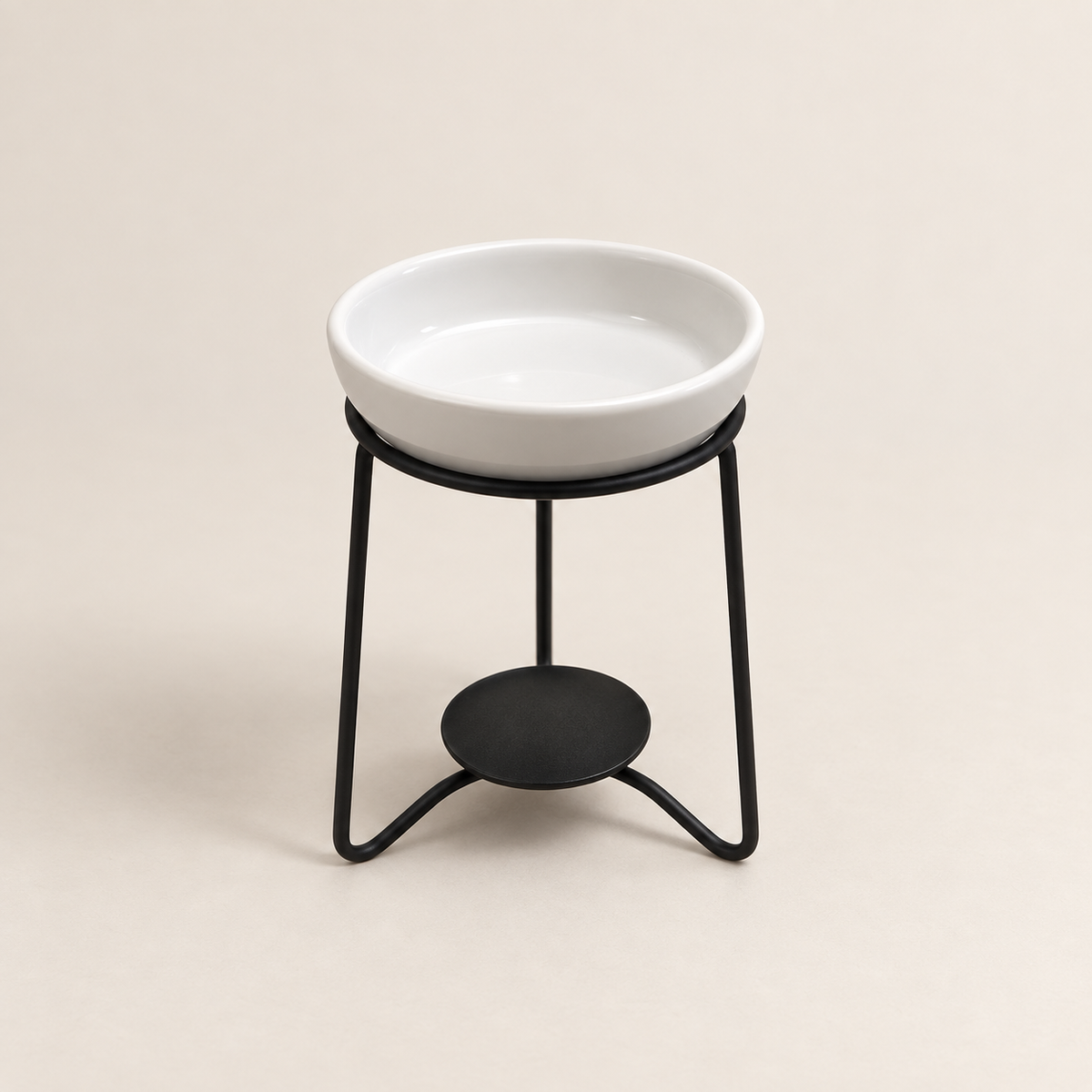 Front view of a white ceramic wax melt burner with fitted dish and black metal stand