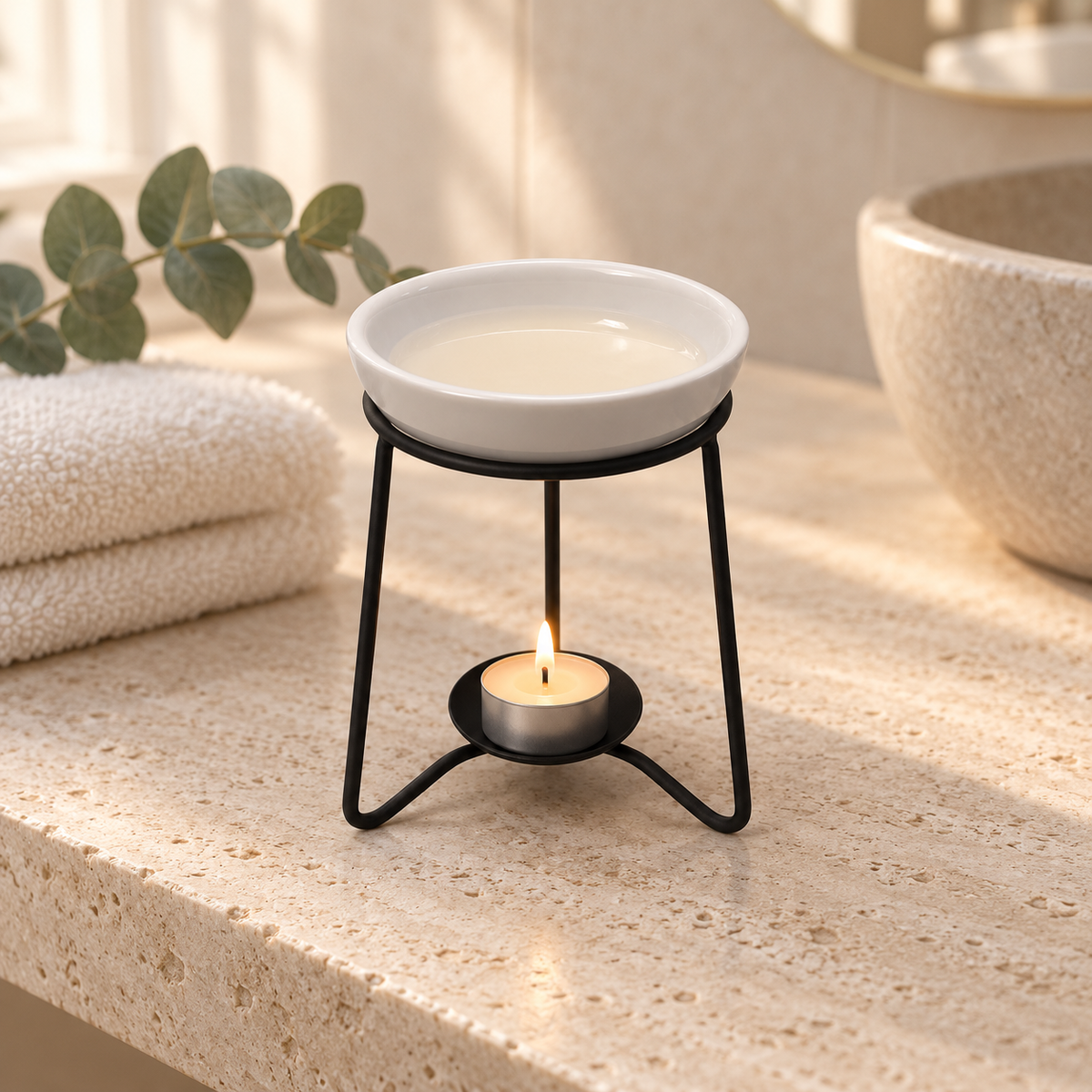 Wax melt burner on a black metal stand in a calm neutral spa setting