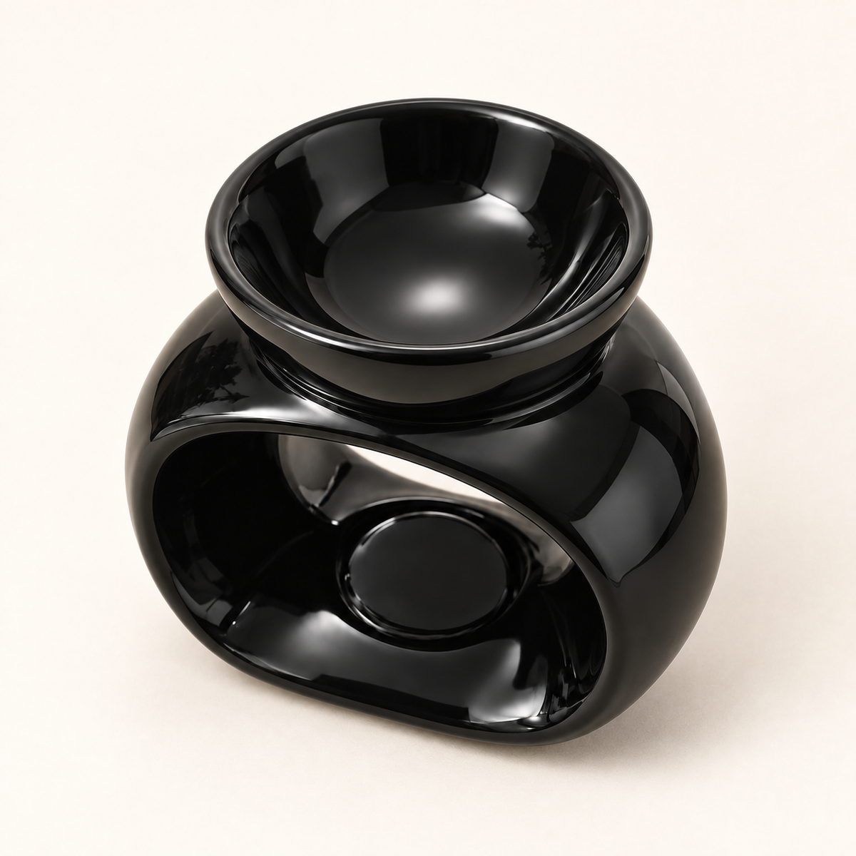 Elevated view of a black ceramic wax melt burner showing the wax dish and tealight opening.